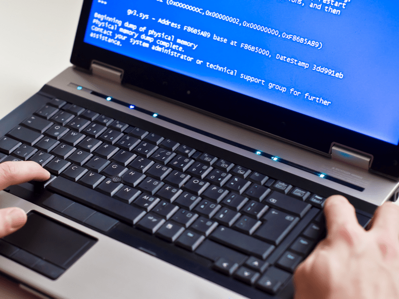 man rebuilding computer code on a laptop